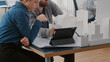 © DC Studio - Close up of colleagues working with tablet and building model to design construction layout. Man and woman looking at digital device and analyzing maquette for urban development.