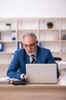 © Elnur - Old male employee and too much work in the office