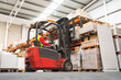 © miguel - Caucasian male sitting on a forklift working in a warehouse