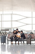 © Blue Jean Images - Happy young family waiting for flight at the airport