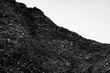 © kheartmanee - A pile of coal on a white background.