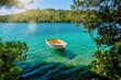 A picturesque summer scene, with a rowboat tied to the shore of Veliko Jezero Lake, in Mljet National Park, Croatia.