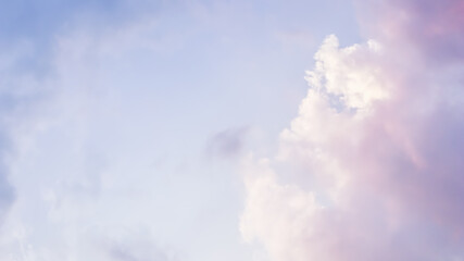 Wall Mural - Blue sky background with white and pink clouds at sunset. High quality photo