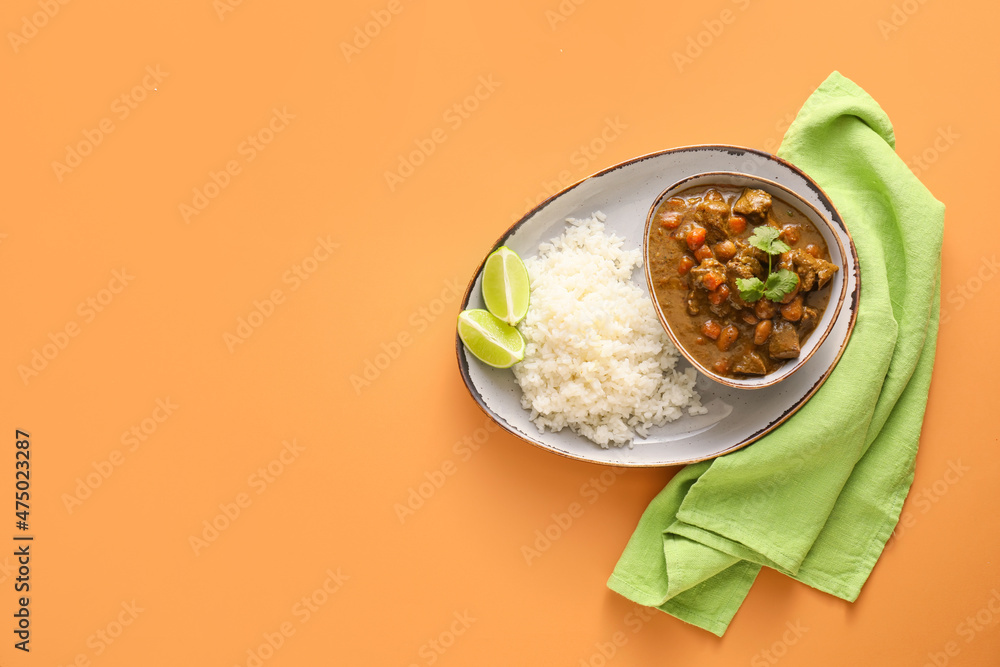 Plate with tasty beef curry and rice on color background