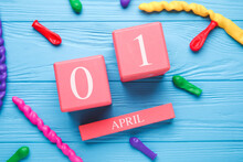 Calendar With Date Of April Fools Day And Balloons On Color Wooden Background