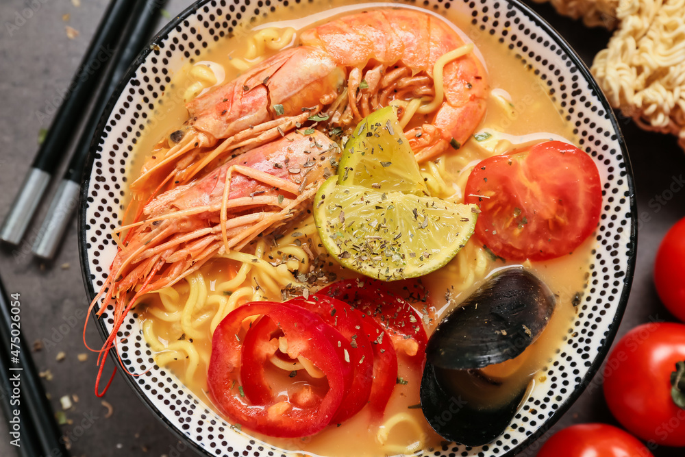 Bowl of tasty Thai soup on dark background