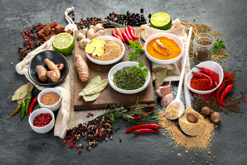 Wall Mural - Assortment of spices on gray background.