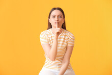 Young Woman Showing Silence Gesture On Color Background