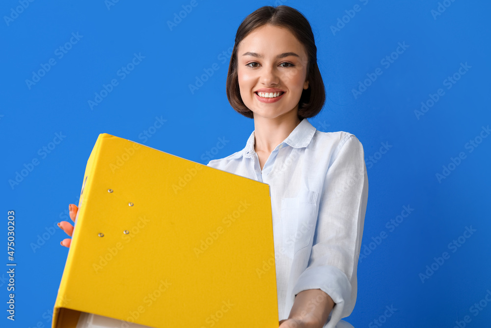 Beautiful young woman with folder on color background