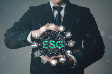 Close up of businessman hand holding to ESG icon concept for environmental, social, and governance in sustainable and ethical business on the Network connection