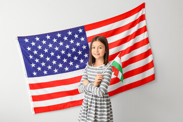 Wall Mural - Pupil of language school near light wall with USA flag