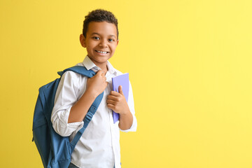 Canvas Print - Little African-American student on color background