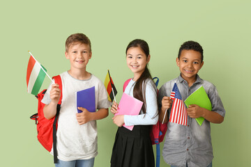 Wall Mural - Pupils of language school with different flags on color background