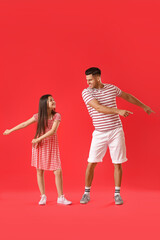 Wall Mural - Dancing man and his little daughter on color background