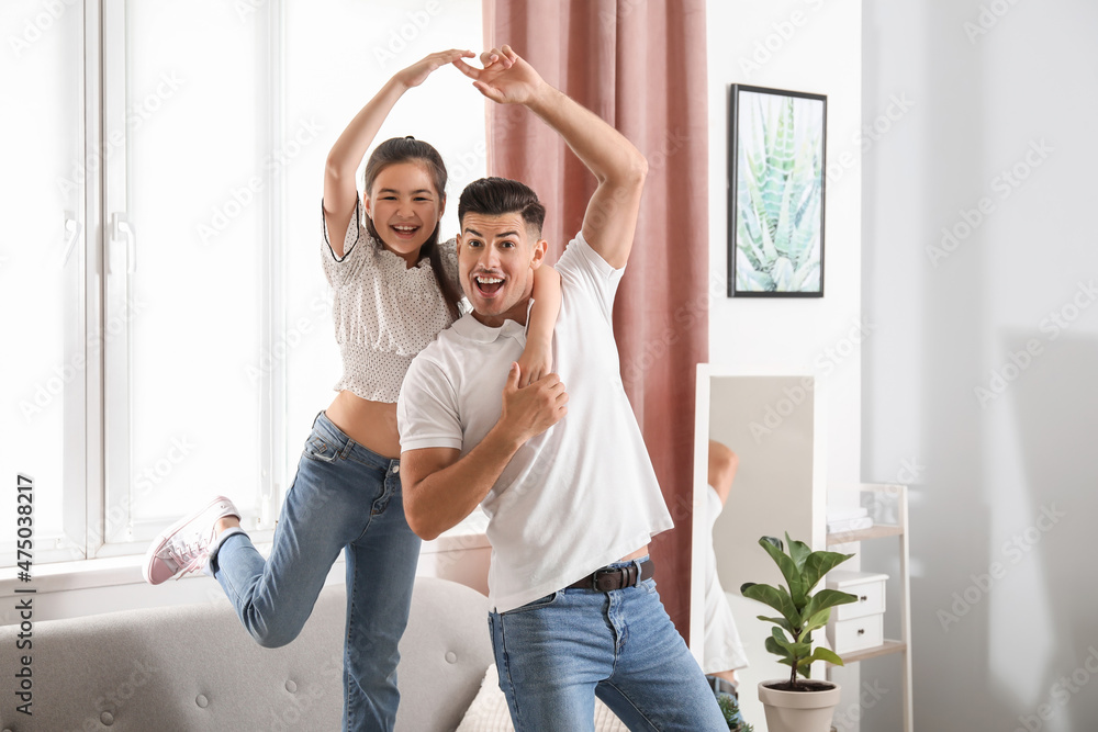 Man and his little daughter dancing at home