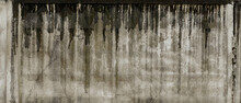 Texture Of Grey Concrete Wall With Dark Water And Oil Marks Running Vertically Down And Many Marks And Lines