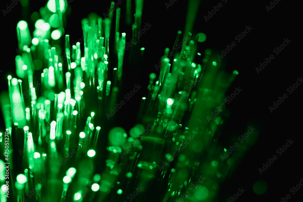abstract green on black bokeh background overlay layer. sparks and ...