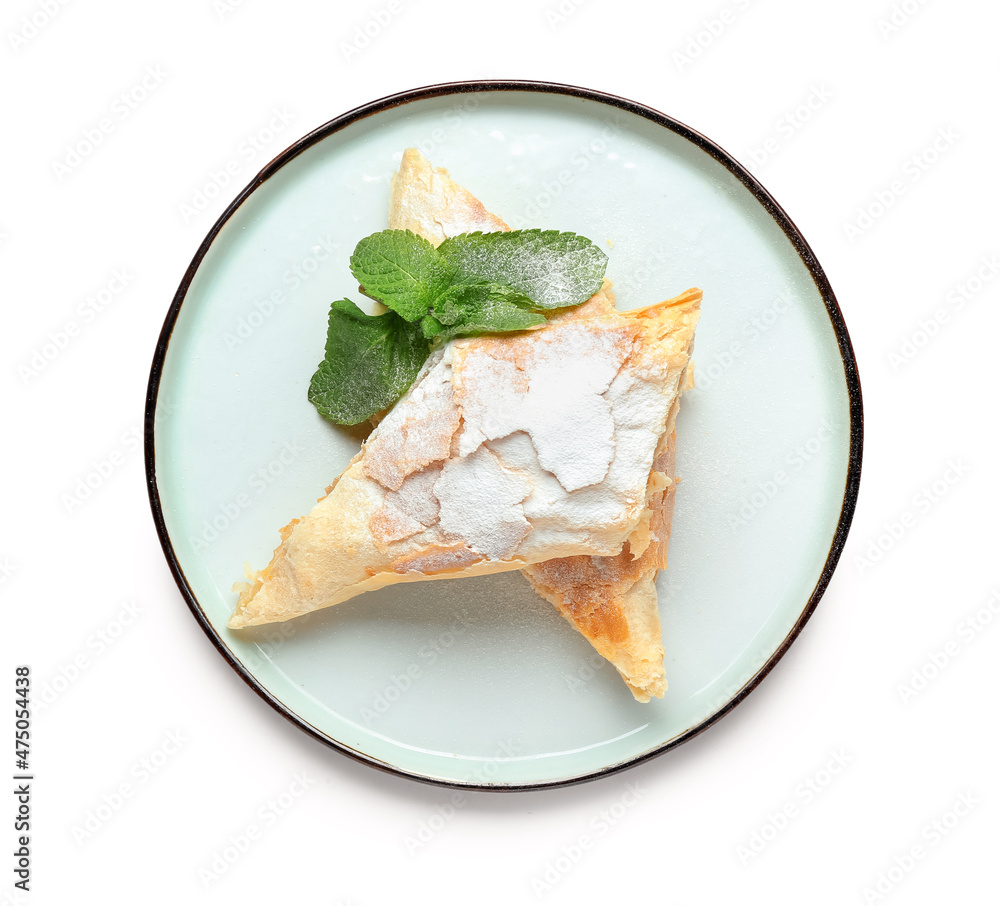 Plate with pieces of tasty apple strudel on white background