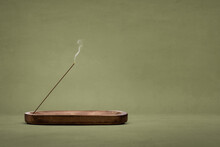 Smoking Incense Stick In A Wooden Holder