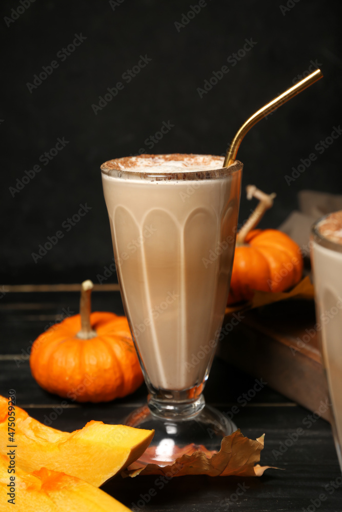 Glass of tasty pumpkin latte on table