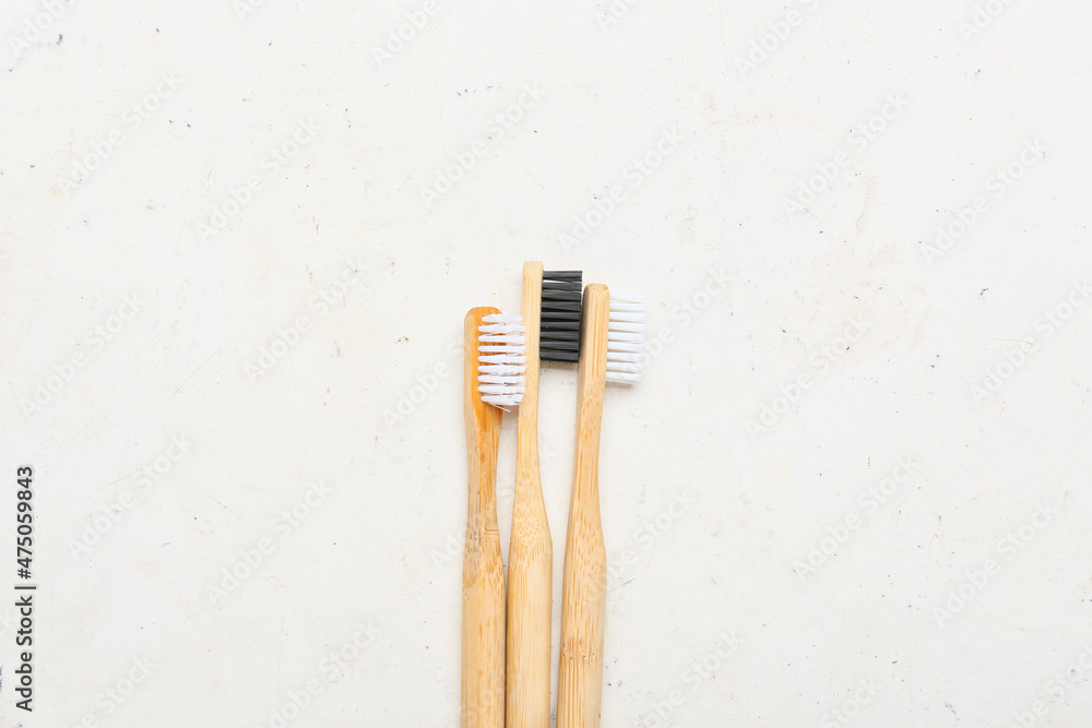 Wooden toothbrushes on light background
