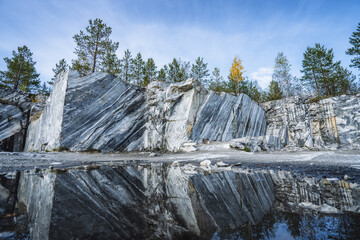 Wall Mural - Italian quarry with smooth sections of marble in the Ruskeala Mountain Park on a sunny summer day