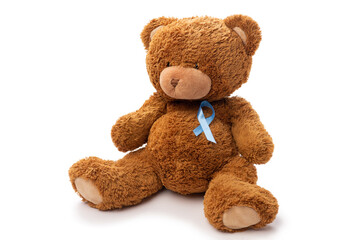Wall Mural - medicine, healthcare and oncology concept - teddy bear toy with blue prostate cancer awareness ribbon on white background