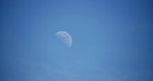 Time Lapse Of Huge Moon Against A Blue Sky