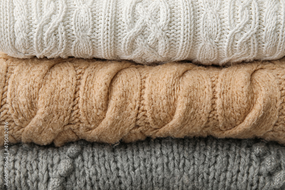 Different knitted sweaters as background