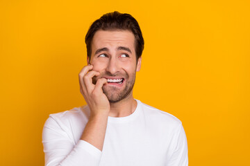 Sticker - Photo of young stressed brunet guy look empty space wear white shirt isolated on bright yellow color background