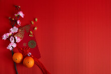 Chinese New Year Festival Decorations. Orange, Leaf, Red Packet, Plum Blossom On Red Background.