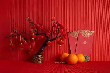 Wall Mural - Chinese new year festival decorations. Orange, leaf, red packet, plum blossom on red background.