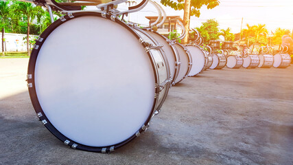 White marching drum head and marching drums on the concrete ground, edited with the sunlight