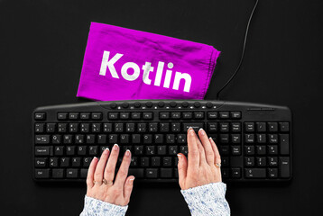 kotlin programming language. rag width word kotlin and hands on pc keyboard.