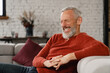 © InsideCreativeHouse - Amused laughing smiling caucasian mature middle-aged man relaxing resting on the couch sofa, feeling well with eyes closed at home