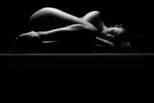 Nude Woman Sleeping And Resting Sensual Naked Isolated On Black Studio Background