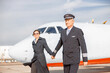 © Kostiantyn - Aircraft pilot and his wife waking hand in hand at airport