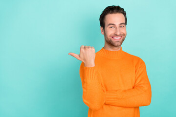 Wall Mural - Portrait of positive satisfied man indicate thumb empty space offer isolated on teal color background