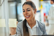© bnenin - Hardworking caucasian woman, writing on sticky notes in the office.