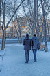 © vladimir subbotin - A man with his visually impaired friend walks along a snow-covered alley of the park