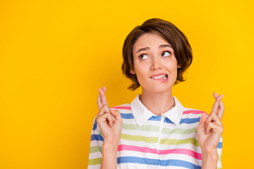 Poster - Photo of worried young brunette lady look empty space wear white t-shirt isolated on yellow color background