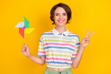 Photo Of Cool Millennial Brunette Lady Hold Toy Wear White T-shirt Isolated On Yellow Color Background