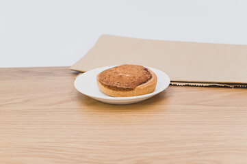 Sticker - white plate with delicious organic vegan almond pie on a wooden tabletop