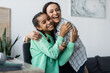© LIGHTFIELD STUDIOS - happy african american woman holding mascara while embracing teenage daughter at home