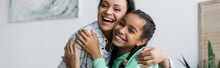 Cheerful African American Mother And Teenage Daughter Hugging While Looking At Camera At Home, Banner