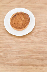 Canvas Print - white plate with delicious organic vegan almond pie on a wooden tabletop