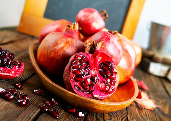 Wall Mural - still life with red granates, pomegranates on wooden plate