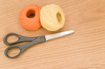 Poster - decorative rustic yellow orange yarn ball and scissors on a wood