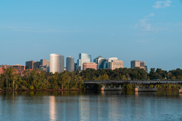 Panoramic view from Washington towards Arlington financial downtown city skyline at sunrise over the Potomac River. Virginia, USA. Business building facades as a concept of prosperous career.