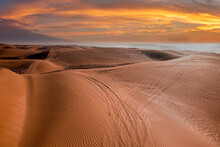 Beautiful Sunset Over Sand Dunes With Tyre Marks At Beach Against Dramatic Sky, Tyre Marks On Sand At Beach